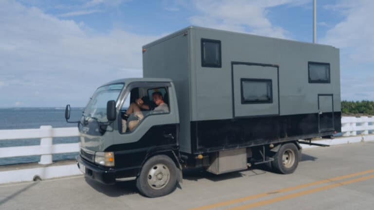a man sitting in the driver seat of a truck