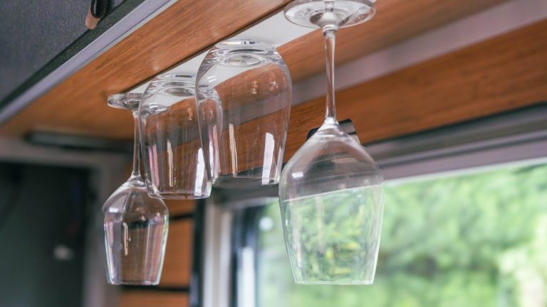 Magnetic glass from silwy® secured on a hanging cabinet in a camper van, perfect for travel and van life